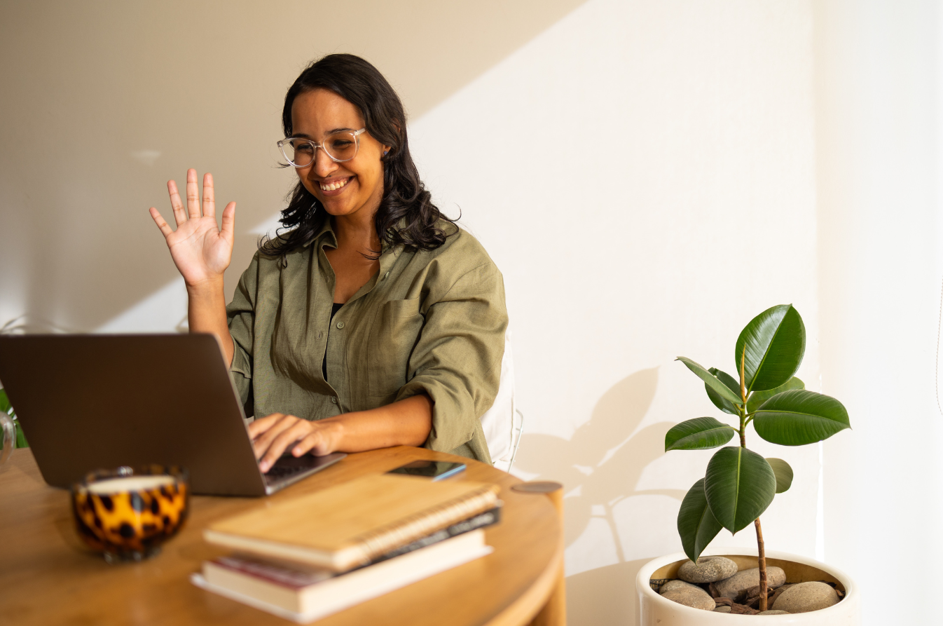Female counsellor waving during individual online clinical supervision, one-to-one professional support across Australia delivered in English and Spanish