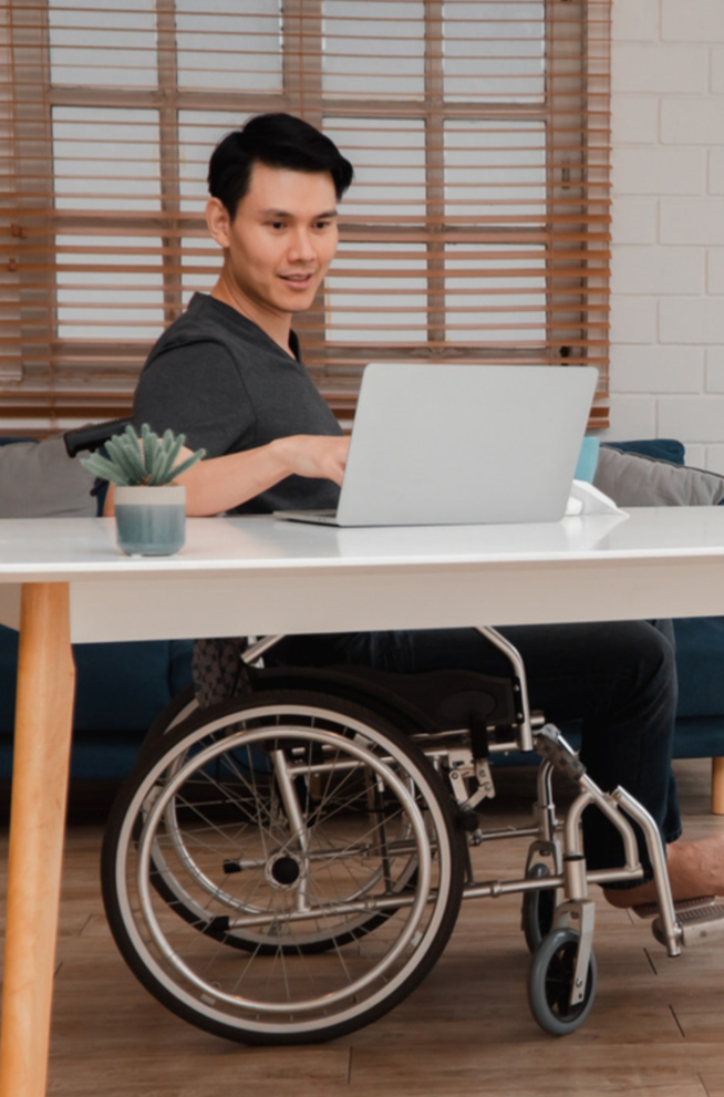 ndis-participant-online-counselling-from-home NDIS participant receiving online counselling from home using a laptop, promoting independence and mental wellbeing