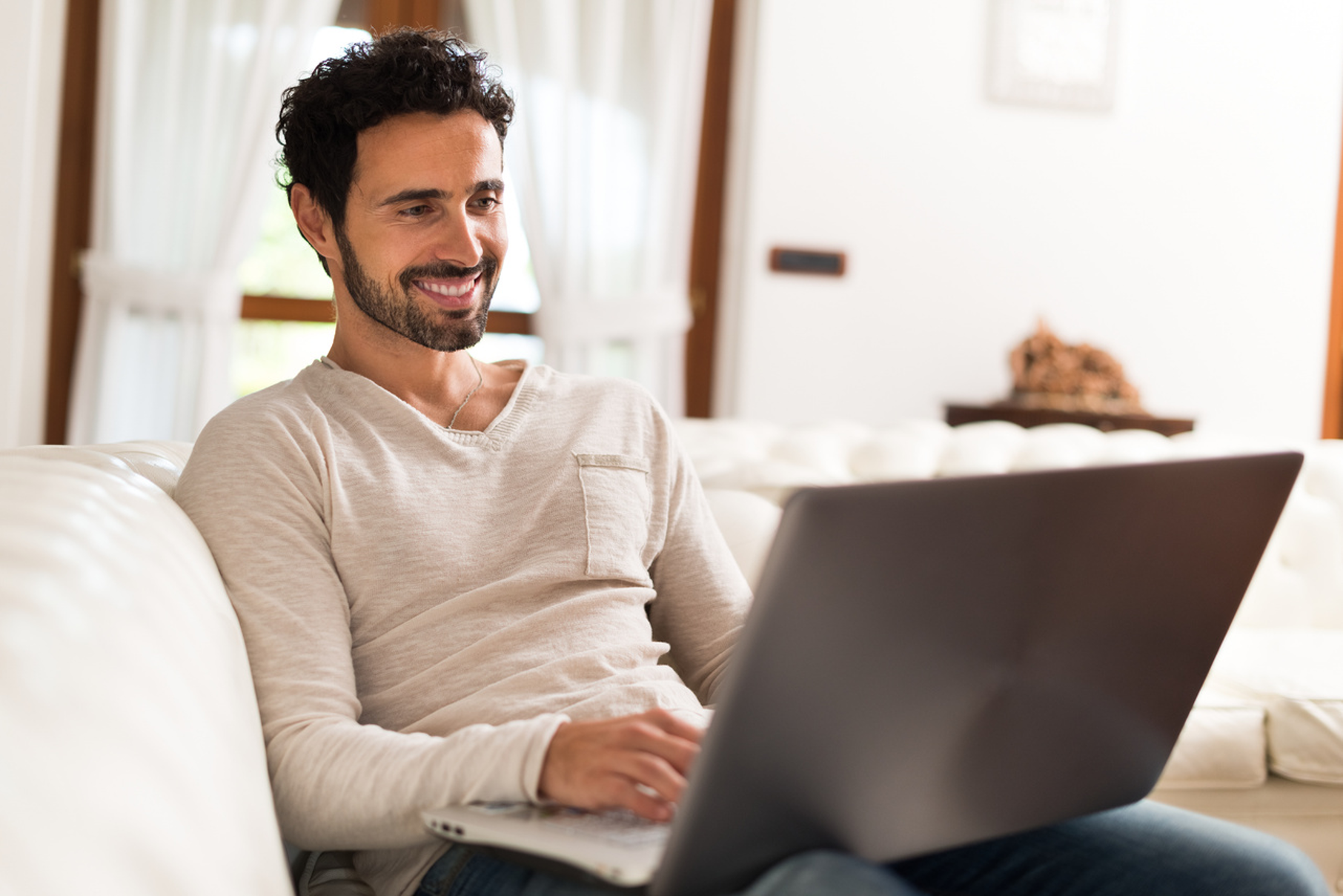 Individual accessing online counselling from home using a laptop in Australia, in English and Spanish